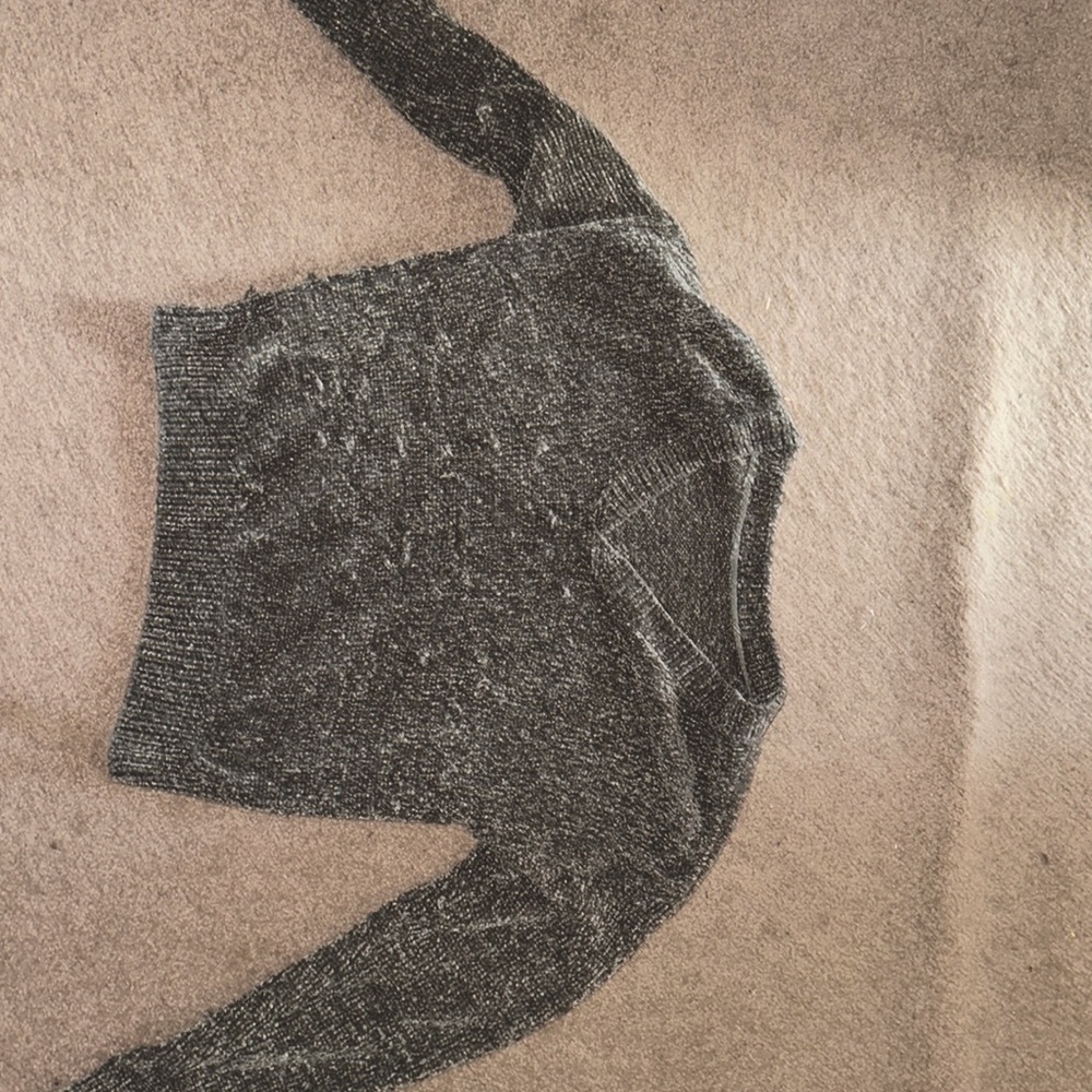 It’s a navy green sweater with a v cut. The v cut is a little low.